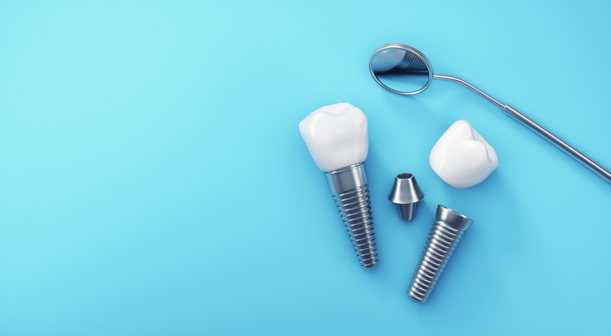 Dental implants isolated on blue background with copy space